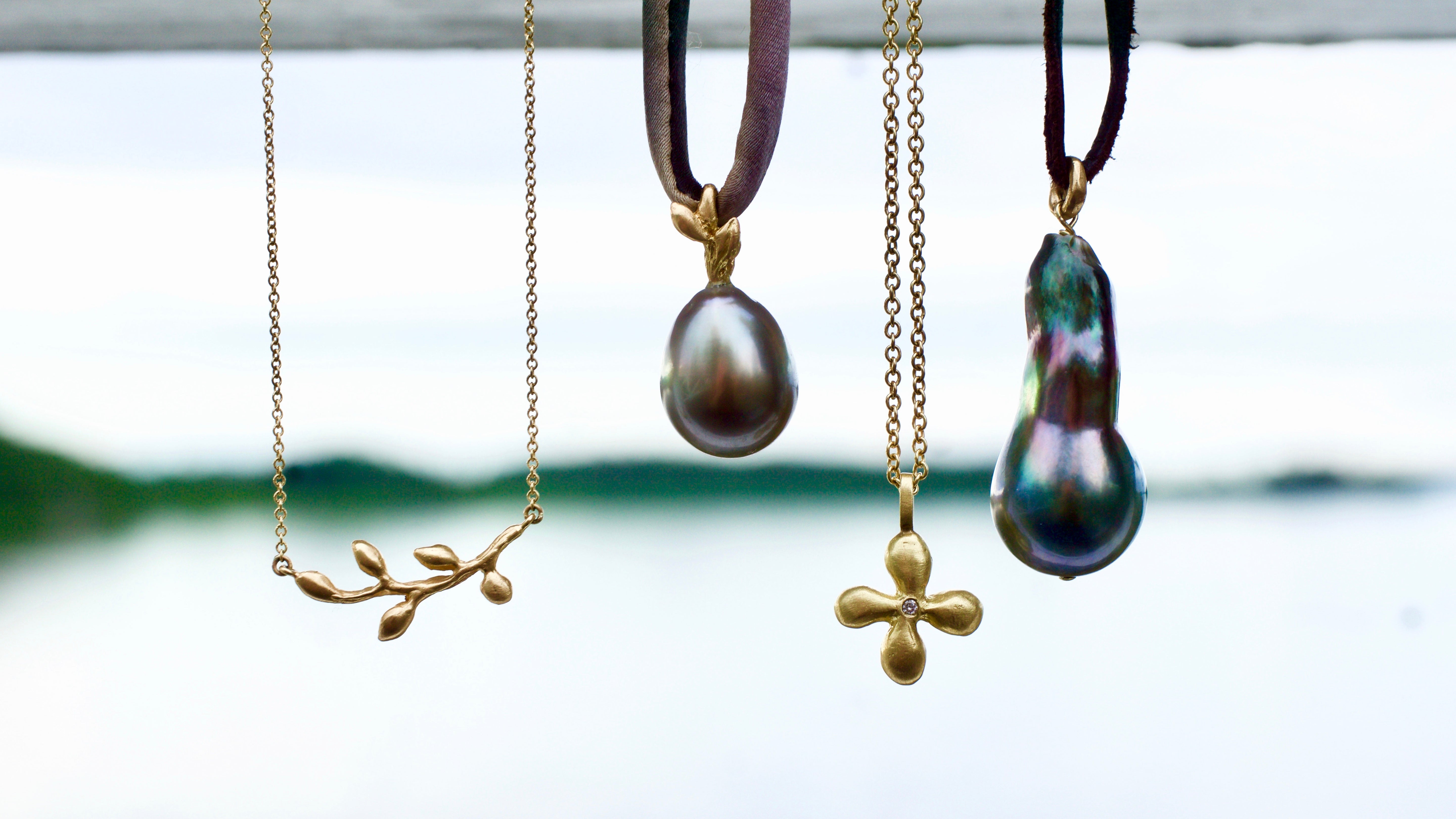 Leaf and Tahitian pearl necklaces in recycled gold