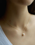 Small Akoya white pearl hanging from a 16 inch 18 karat gold chain